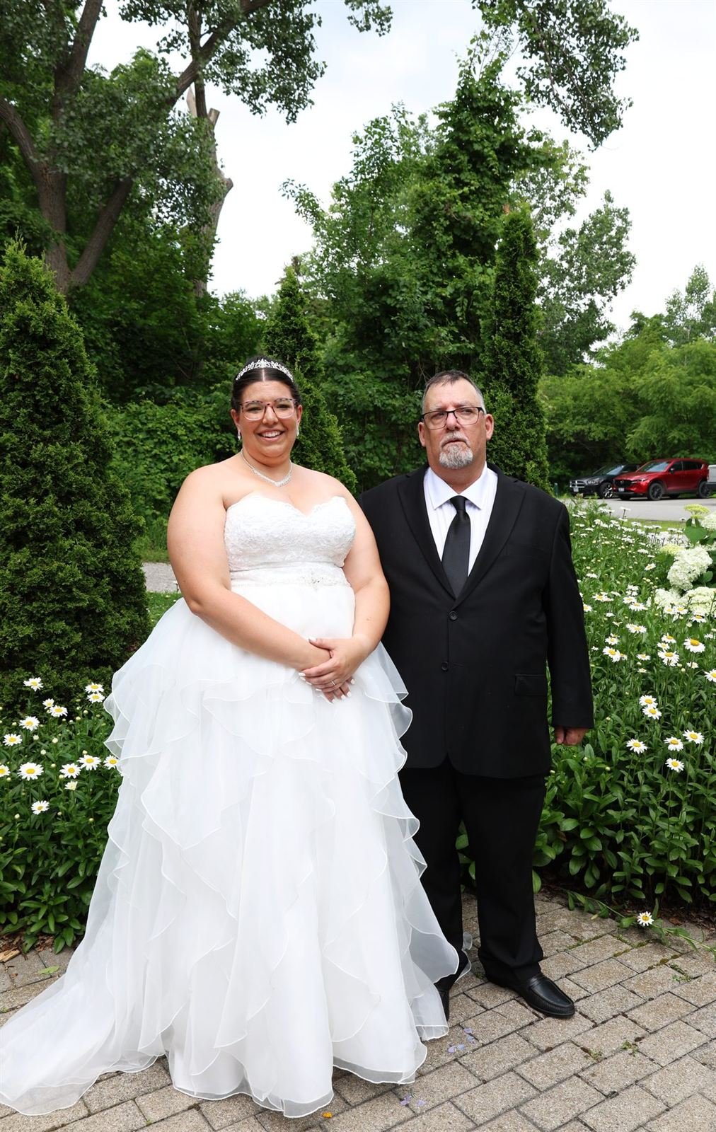 Garden portrait — bride and groom among white flowers